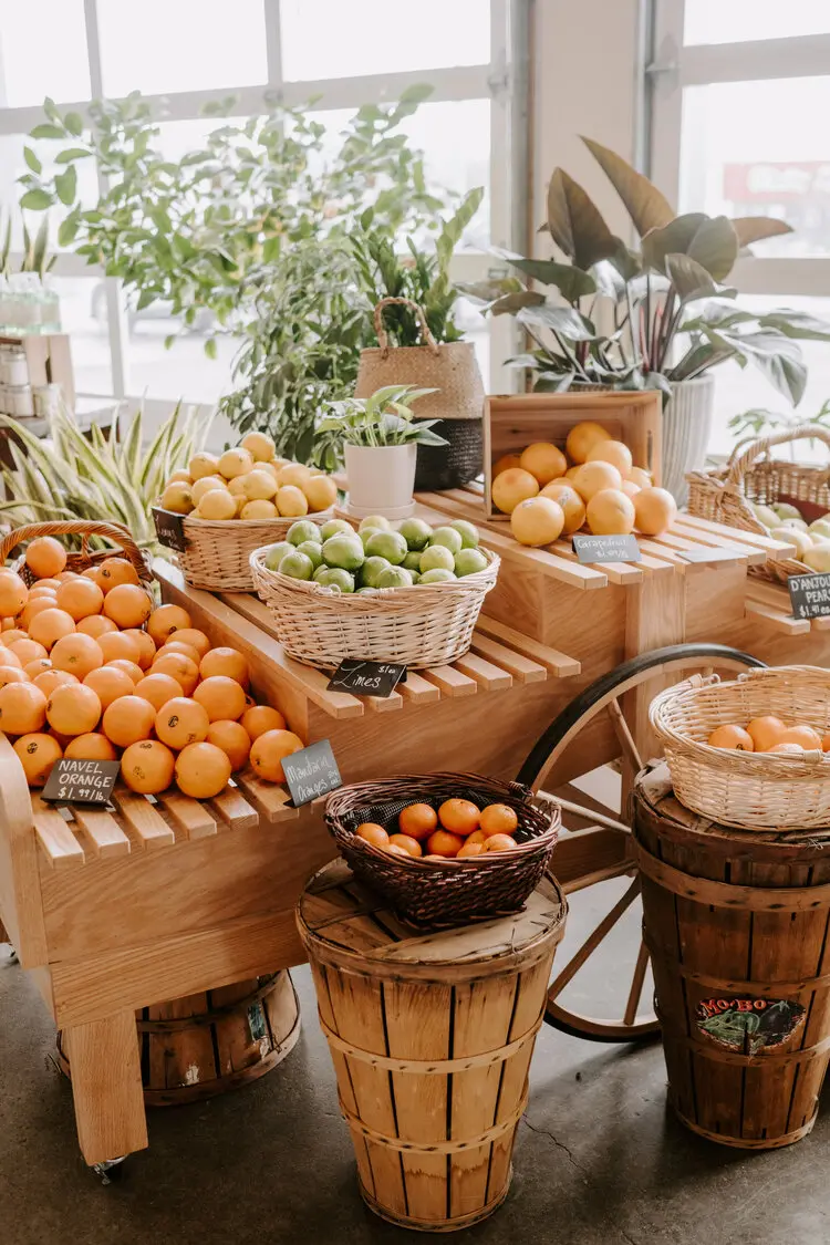Fresh citrus fruits in wooden baskets and crates